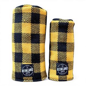 Two yellow and black checkered golf headcovers with 'Reinland' branding on a white background