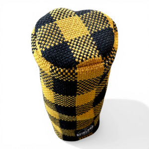 Golf club head cover with black and yellow checkered pattern on a white background