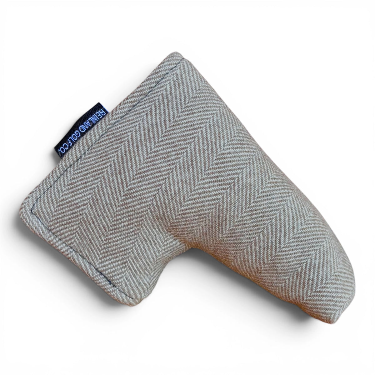 Tan and cream herringbone patterned golf club head cover on a white background